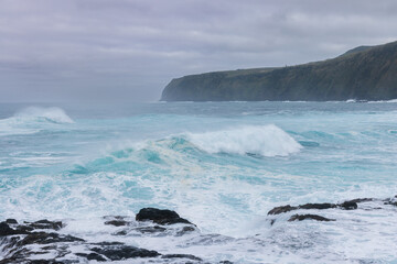 Waves crashing on rocks at the west coast of the isle of Sao Miguel, Azore Portugal