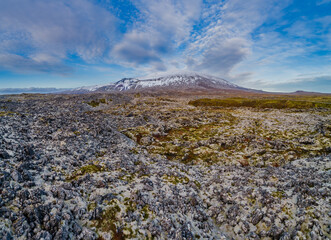 Aerial view over old moss covered lava field with the strato volcano Sneafellsjökull in the...