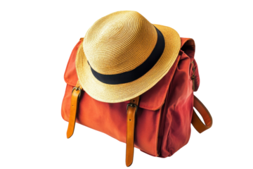 A stylish straw hat rests atop a vibrant orange bag, perfect for summer adventures and travel isolated on transparent background