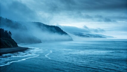 Foggy coastal cliffs and ocean in blue tones