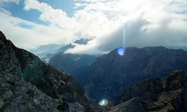 Scenic mountain landscape featuring rocky terrain and cloudy sky at midday