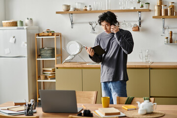 Focused young man engaged in e-learning while seated at a cozy kitchen table