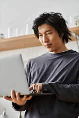 Young man engaged in online studies from the comfort of his home environment