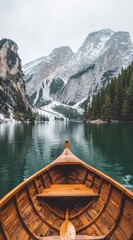 A wooden boat on the lake Braies in the Dolomites, photography, front view, mountains with a snowy background, 