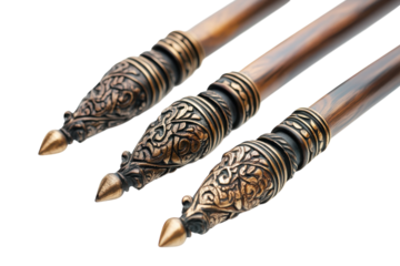 Artistic wooden writing instruments with intricate brass detailing on a clean background isolated on transparent background