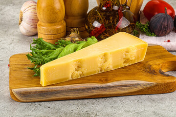 Hard parmesan cheese triangle over board