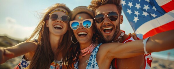 Three youthful pals enjoy laughter and fun on the beach while holding an american flag