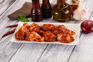 Raw marinated buffalo chicken wings