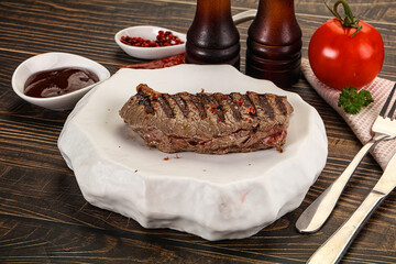 Grilled beef striploin steak with sauce