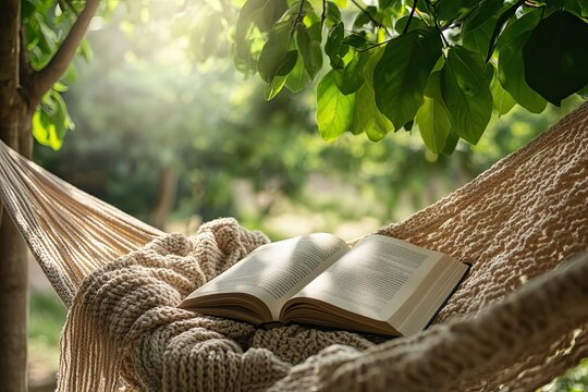 A peaceful reading hammock with a knit blanket, an open book, and dappled sunlight