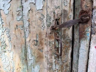 Old rusty door lock on an old wooden door