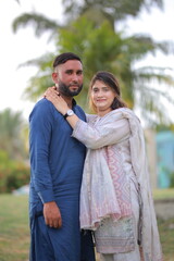 Naklejka premium Happy young Pakistani Indian couple posing together