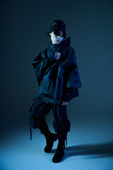 Fototapeta premium Stylish young man showcasing modern fashion in an artistic urban setting at dusk