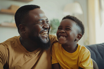 Fototapeta premium Father and son are laughing together on the couch