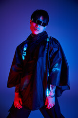 Stylish young asian man posing confidently against a vibrant blue and red background