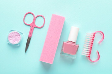 Set of different manicure tools on turquoise background, flat lay