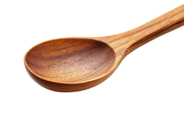Handcrafted wooden spoon resting on a clean white surface, showcasing its natural beauty and texture isolated on transparent background
