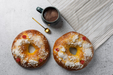 Roscón de reyes, spanish epiphany cake with candied fruit and hot chocolate beverage, festive dessert enjoyment