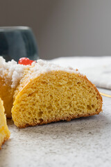 Slice of roscón de reyes showing its fluffy texture and candied fruit