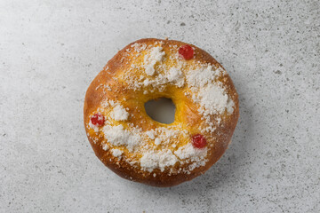 Roscón de reyes, traditional spanish epiphany cake, sprinkled with pearl sugar and candied fruit