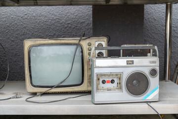 Vintage tape recorders and TV sets on the shelves