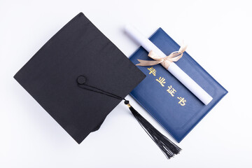 Bachelor hat and graduation certificate on white background