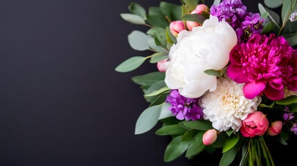 Bright floral arrangement featuring peonies and dahlias on a dark background adds elegance to any setting