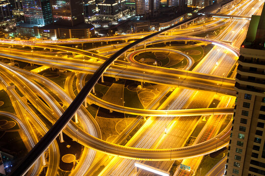 Night traffic on a busy intersection on Sheikh Zayed highway, Dubai, United Arab Emirates