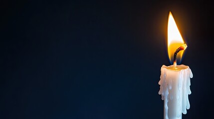 One candle burning in a dark room . 