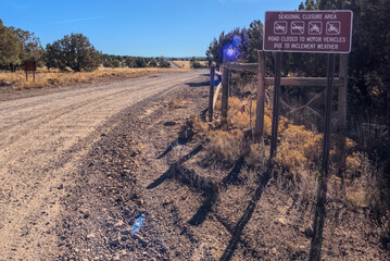 A warning sign stating that the road can be closed seasonally, Coconino National Forest, Arizona