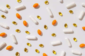 Different capsules vitamins, natural supplements, nutraceuticals on light gray background top view....