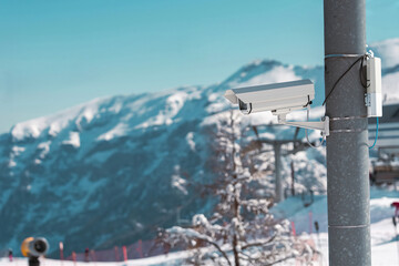 Surveillance camera monitoring ski slope with snowy mountains in background. In Folgarida