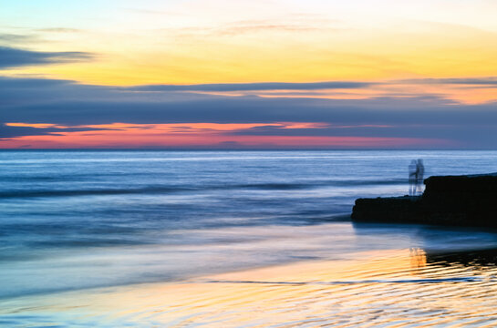Colourful sunset over the English Channel as seen from Brighton beach, City of Brighton and Hove, East Sussex, England