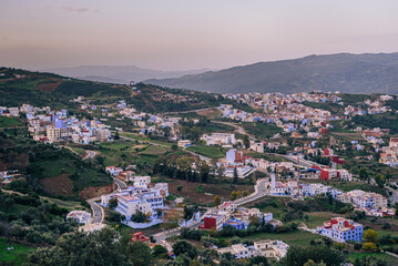 Sunrise over the valley surrounding the Medina and blue houses on the skyline of Chefchaouen