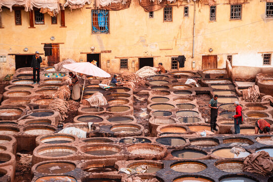 Rows of dye-filled stone basins in a traditional leather tannery in Fes