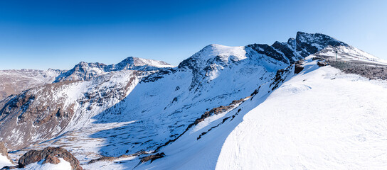 Snowy high altitude summits of the Spanish Sierra Nevada, in front of Pico de la Veleta, Mulhacen and Alcazaba, Andalusia, Granada, Spain