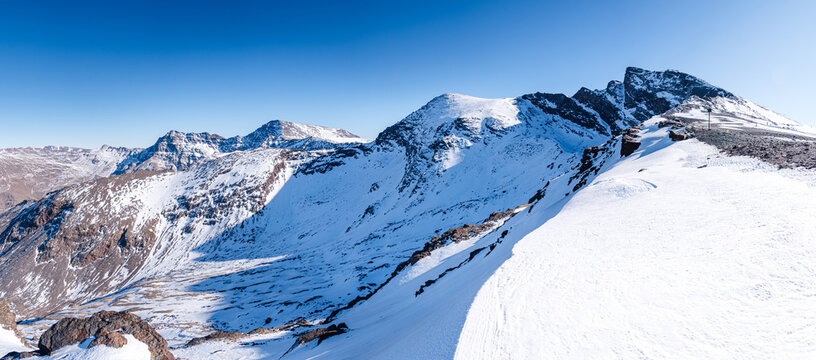 Snowy high altitude summits of the Spanish Sierra Nevada, in front of Pico de la Veleta, Mulhacen and Alcazaba, Andalusia, Granada, Spain