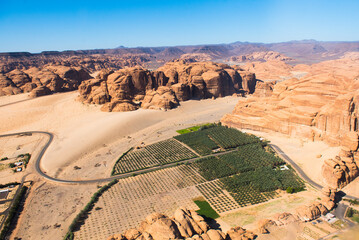 Aerial view from helicopter, of a farm in an ancient oasis in the desert with canyons of the Ashar Valley,AlUla, Medina Province