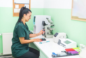 Female veterinarian preparing medical sample for analysis in lab