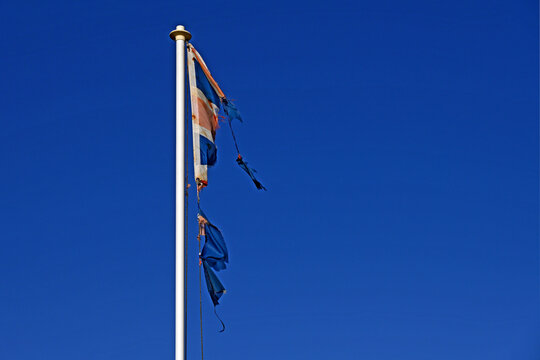 Torn Union Jack as symbol of economic decline