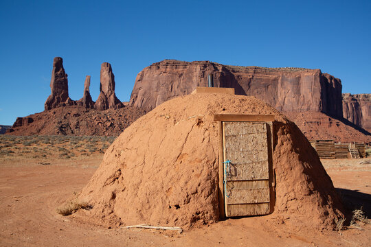 Navajo Hogan House, Three Sisters in the background, Monument Valley Navajo Tribal Park, Utah