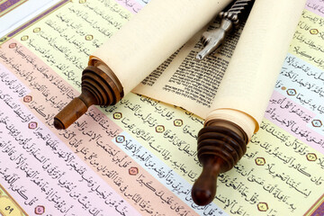 Torah scrolls in Hebrew, Yad and Quran in Arabic, relationship between Muslims and Jews, interfaith peace concept