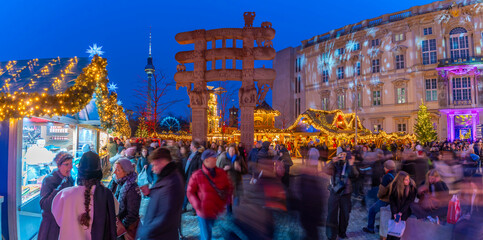 Christmas market stalls in Vorplatz Berliner Schloss at Christmas and Berlin TV Tower in background, Mitte, Berlin, Germany