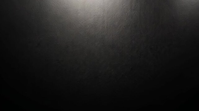Subtle light transitions on textured black surface in minimalist abstract sequence