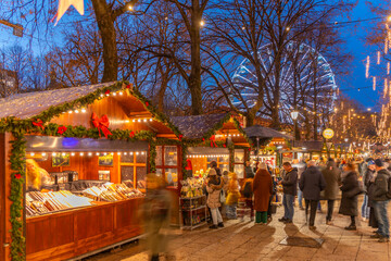 View of Christmas market and ferris wheel on Karl Johans Gate at dusk, Oslo, Norway
