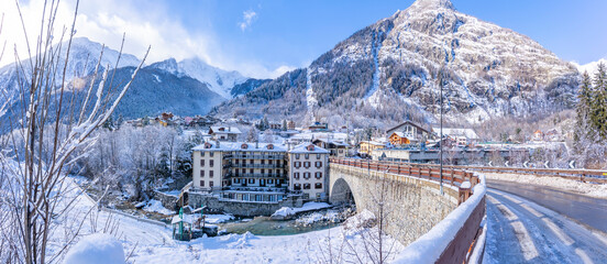 View of snow covered trees, mountains and Dolonne from Courmayeur in winter, Courmayeur, Aosta Valley, Italian Alps