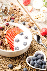 Muesli with organic berries and nuts. Oat muesli with raspberry, blueberry, strawberries, almond, cashew, banana. Healthy food, top view