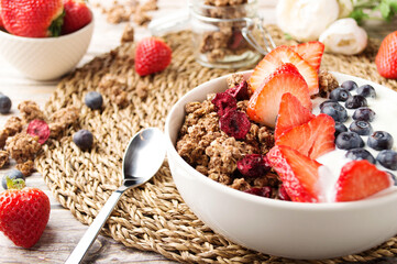 Muesli with organic berries and nuts. Oat muesli with raspberry, blueberry, strawberries, almond, cashew, banana. Healthy food, top view