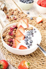 Muesli with organic berries and nuts. Oat muesli with raspberry, blueberry, strawberries, almond, cashew, banana. Healthy food, top view