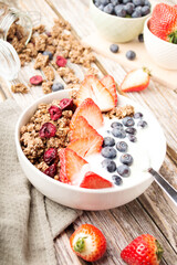 Muesli with organic berries and nuts. Oat muesli with raspberry, blueberry, strawberries, almond, cashew, banana. Healthy food, top view